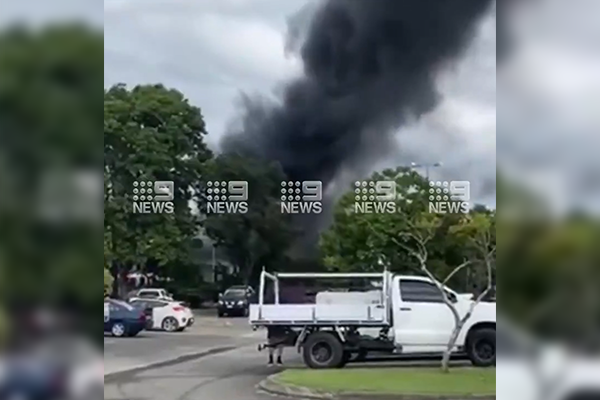 Article image for Warehouse in flames spilling plumes of black smoke in Burleigh Heads