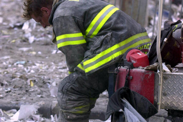 SEPTEMBER 11, 2001 : Overwhelmed firefighter sits amongst debris of World Trade Centre 11/09/01 following terrorist attack on New York. Pic Nathan Edwards.USA / Crime / Bombing / Terrorism / Fireman Picture: Nathan Edwards