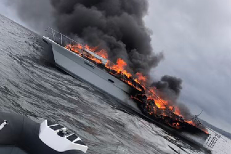 Article image for Couple rescued after boat erupts in flames on Moreton Bay